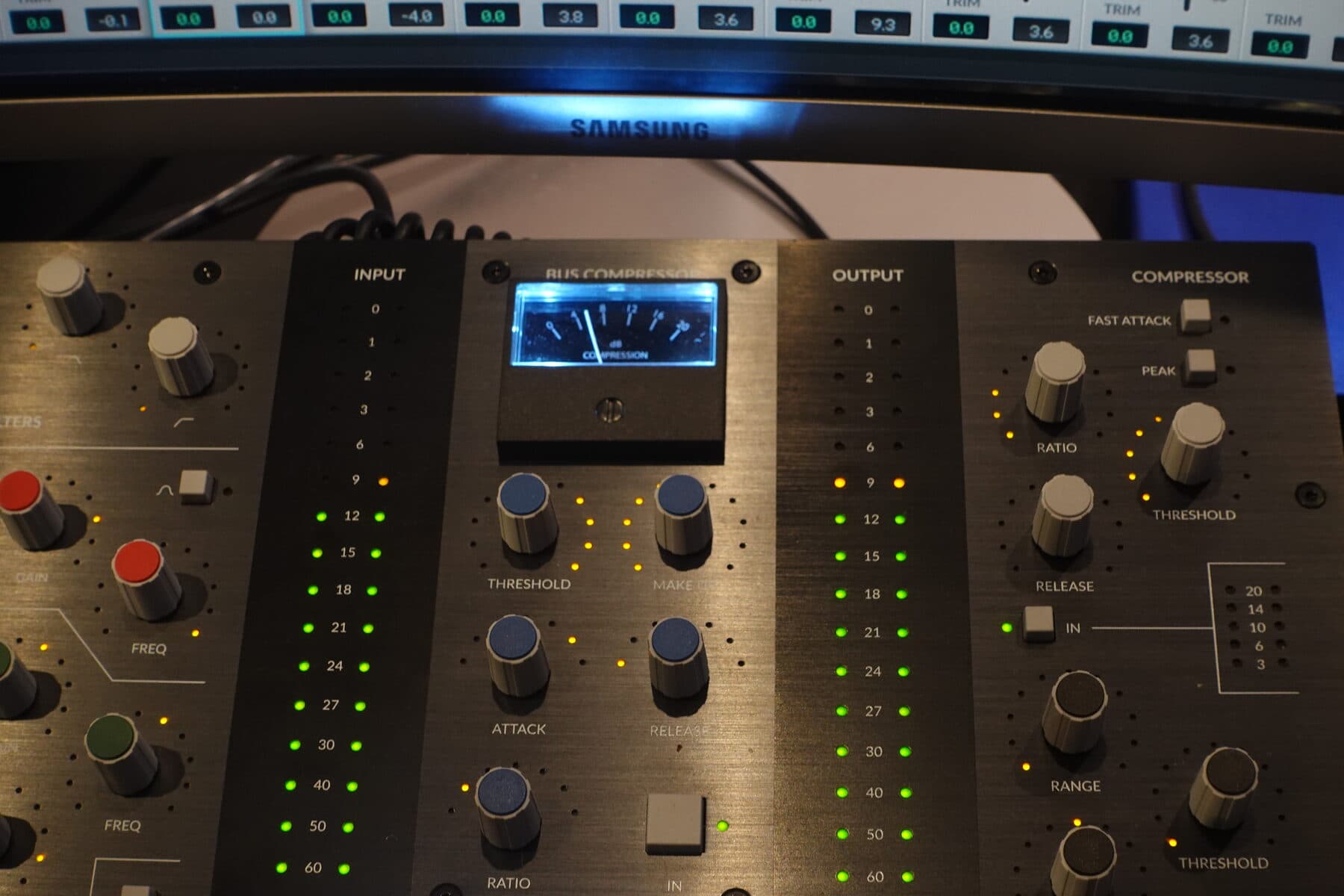 Close-up of the UC1 bus compressor VU meter with input and output LED meters lit